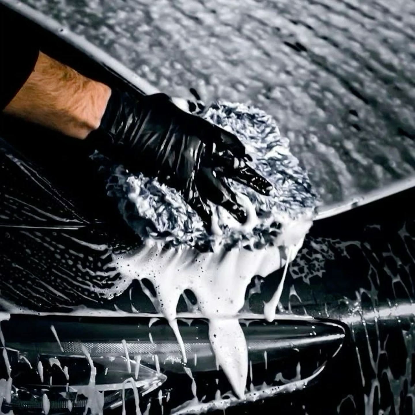 Guante de microfibra con espuma densa sobre auto negro